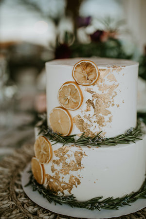 Wedding cake with lemon and rosemary on rustic backgroundの写真素材