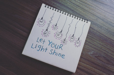 Notepad with the words Let your life shine written on it.