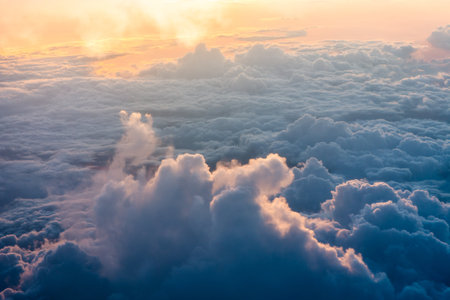 Cloudscape, View from the window of an airplane flying above the clouds at sunset