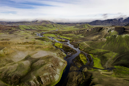 Aerial view of the volcanic landscape of Iceland with the river and mountainsの写真素材