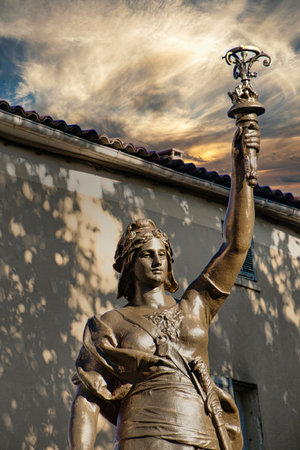 Statue of a woman with a lantern in the city of Lisbon, Portugalの写真素材