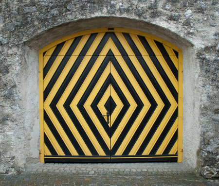 Yellow and black wooden door in old town of Tallinn, Estoniaの写真素材