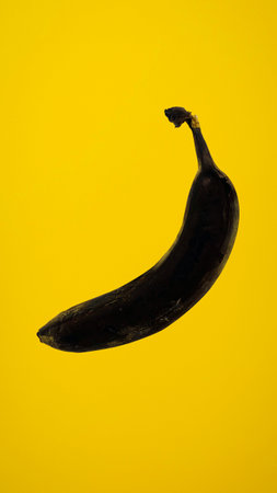 Banana on a yellow background. Minimalistic style. Copy space.の写真素材