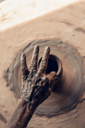 hands of a potter, creating an earthen jar on the circleの写真素材