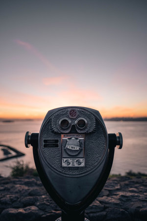 Coin Operated Binoculars on a Rock with a Sunset Skyの写真素材