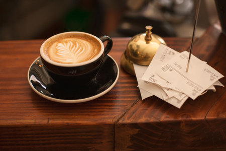 Coffee cup on the wooden table in coffee shop, stock photo