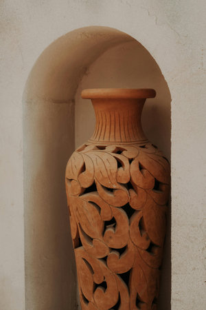 Clay vase on the wall of the house, closeup of photo