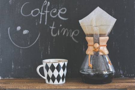 Coffee maker and coffee cup on blackboard background, stock photoの写真素材