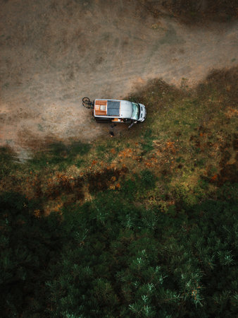 Aerial view of a car on the road in the forest.の写真素材