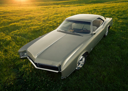 Vintage car on the green grass at sunset. Retro car.