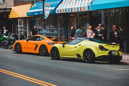 Yellow and orange sport cars parked in the street.の写真素材