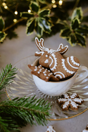 Christmas cookies in the shape of a deer on a glass saucerの写真素材