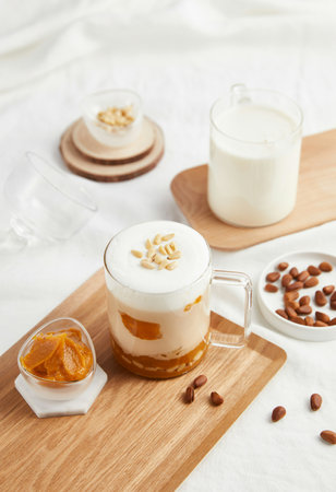 Coffee latte with caramel and nuts in a glass cupの写真素材