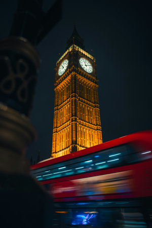 Big Ben and red bus in London at night, United Kingdom.の写真素材