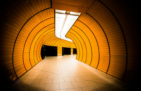 Yellow tunnel in the center of the city with light at the end