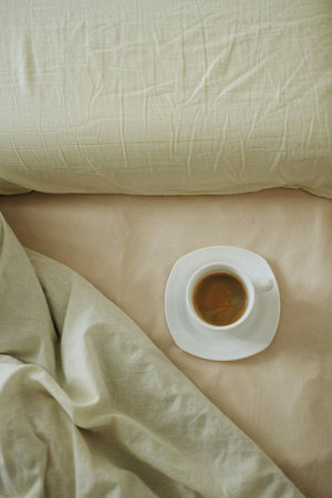 Coffee cup on bed in the morning. Top view.の写真素材