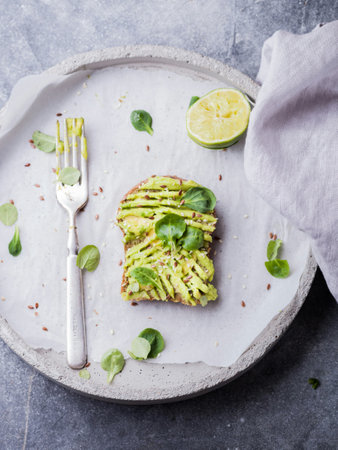 Avocado toast with microgreen and lime, top view, square