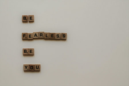 Conceptual image with wooden cubes with the words BE FEARLESS BE YOUの写真素材
