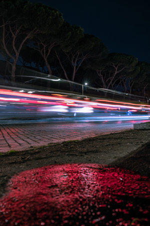 fast-moving car at night. Rome, Italy. low wide angle, long exposure photography technique.の写真素材
