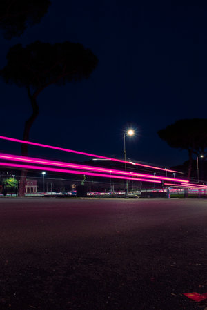 fast-moving car at night. Rome, Italy. low wide angle, long exposure photography technique.の写真素材
