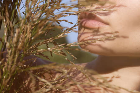 close-up portrait of the lips with bouquetの写真素材