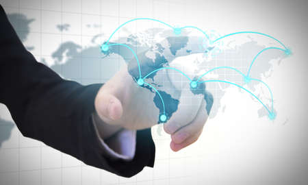 Businessman pressing a modern world map connectingの写真素材