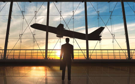 Business man standing silhouette in the airportの写真素材