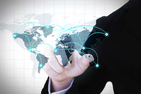 Businessman pressing a modern world map connecting