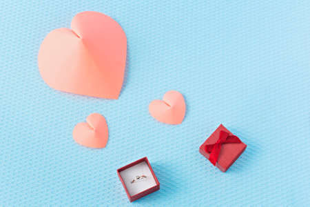 Hearts and ring on a blue background. Valentine's Day. Valentines day greeting card. An offer of...