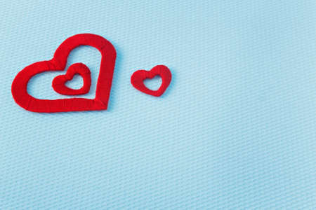 Red hearts on a blue background. Valentine's Day. Valentines day greeting card.