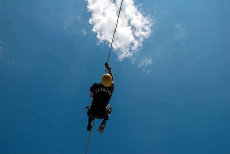 firefighter climbing with ropeの写真素材