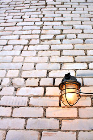 aging lamp on brick wallの写真素材
