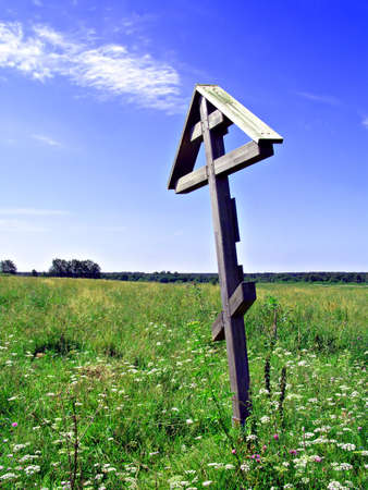 solitary cross on yellow autumn field     の写真素材