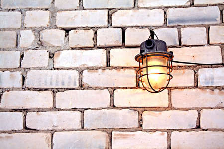 aging lamp on brick wallの写真素材
