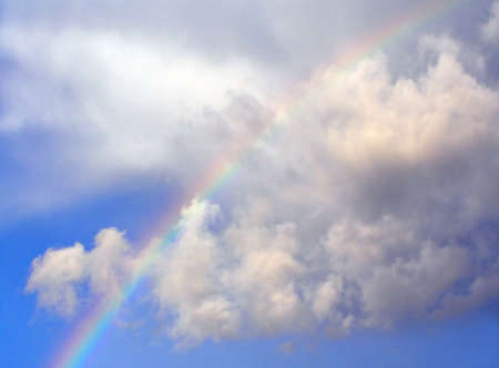 rainbow in cloudy sky      