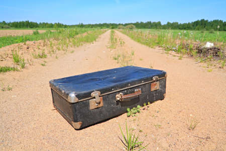 old valise on rural roadの写真素材