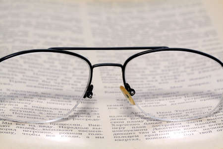spectacles on old bookの写真素材