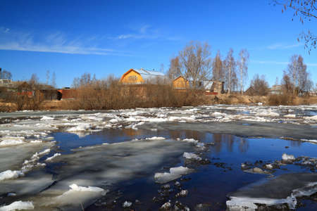 driving of ice on river near villagesの写真素材