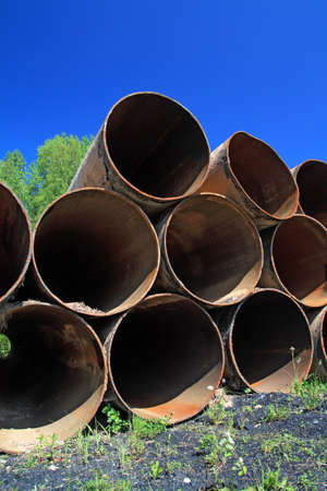 old gas pipes amongst green herb