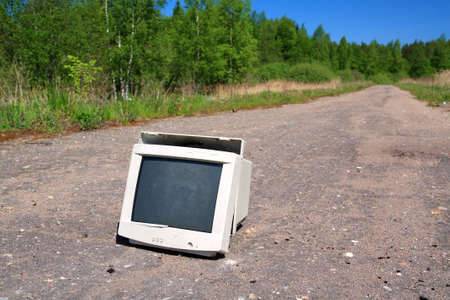 brokenned computer on old roadの写真素材