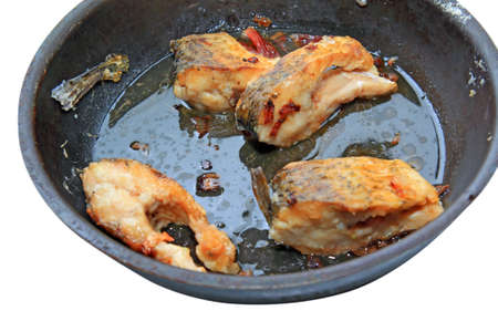 roasted fish on black griddleの写真素材