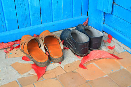 aging footwear on porch of the rural building