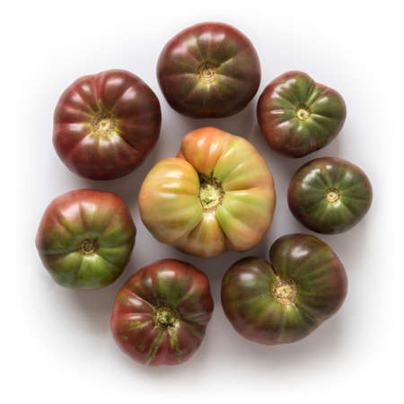 Organic heirloom Brandywine tomatoes in a circle, isolated on white, top viewの写真素材