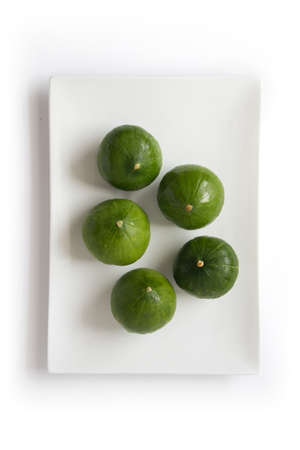 Summer cupcake squash - five vegetables on a plate, isolated on white, top viewの写真素材