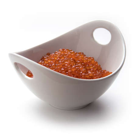 Red salmon caviar in a bowl, isolated on whiteの写真素材