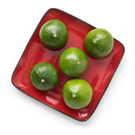 Summer cupcake squash - five vegetables on a plate, isolated on white, top viewの写真素材