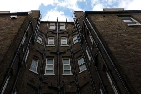 Bottom up shot of a building in Hampstead with the blue cloudy skyのeditorial素材