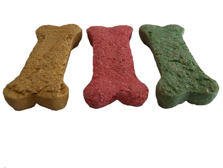 Photo of three dog bisquits/bones in different colorsの写真素材