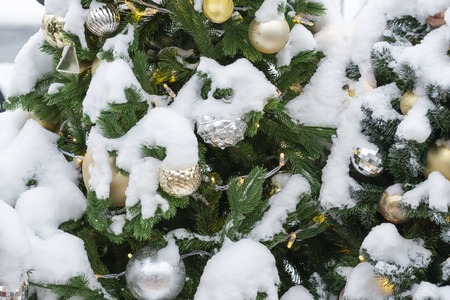 Christmas tree with decorations in the snow. Close-upの写真素材