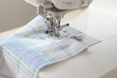 Sewing machine part, fabric, threads and accessories for sewing close-up.の写真素材